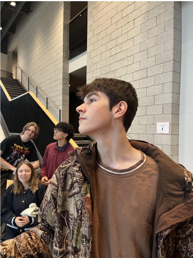 Axel Lauthner gazes toward the PAC window while conversing with friends. Lauthner spends much time in this area, since he's heavily involved with the drama department. 